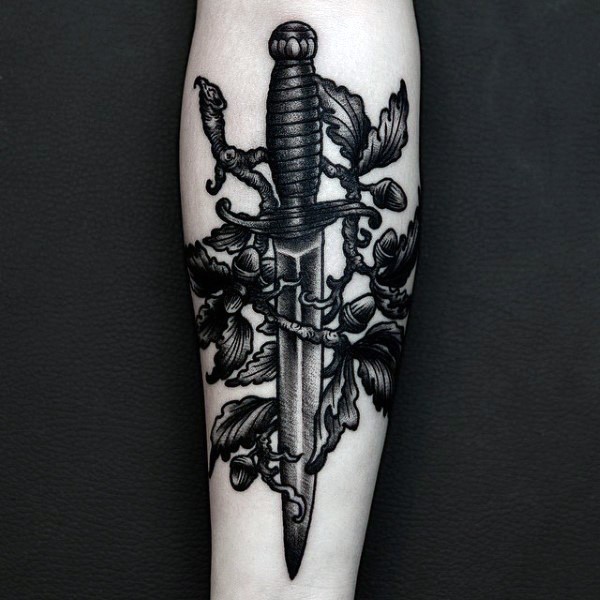 Black ink engraving style forearm tattoo of small dagger with tree and leaves