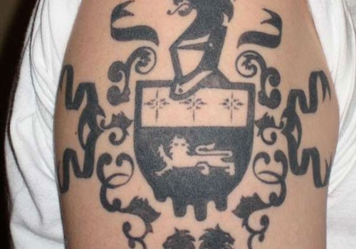 Black ink family crest tattoo on shoulder