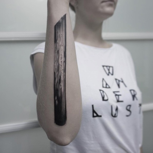 Black ink forearm tattoo of big wooden stick