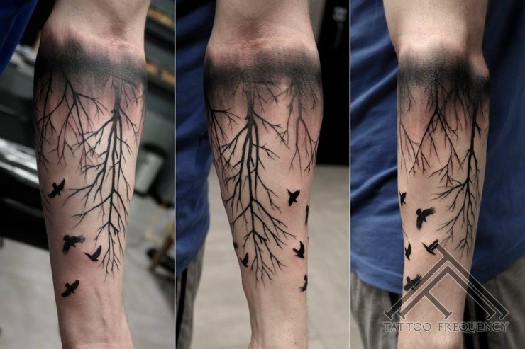 Black ink forearm tattoo of black forest with birds