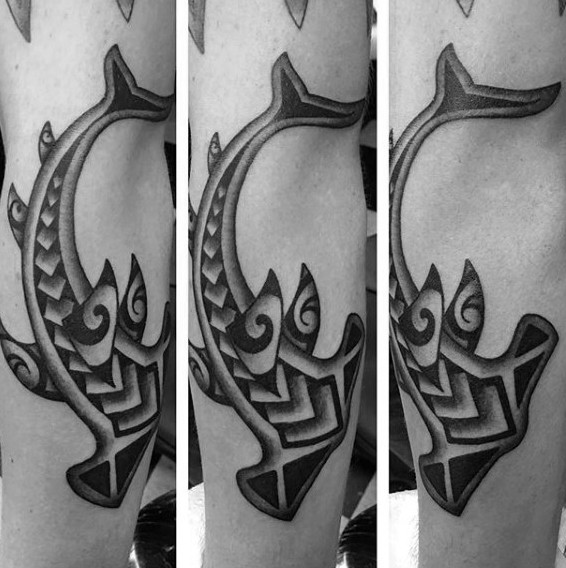 Black ink forearm tattoo of hammerhead shark stylized with Polynesian ornaments