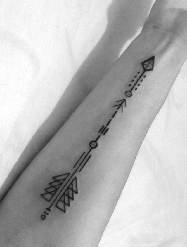 Black ink geometric arrow tattoo on arm