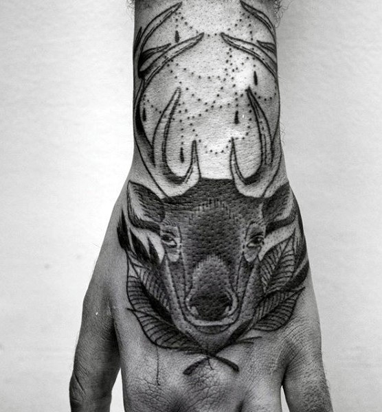 Black ink hand tattoo of deer head with leaves
