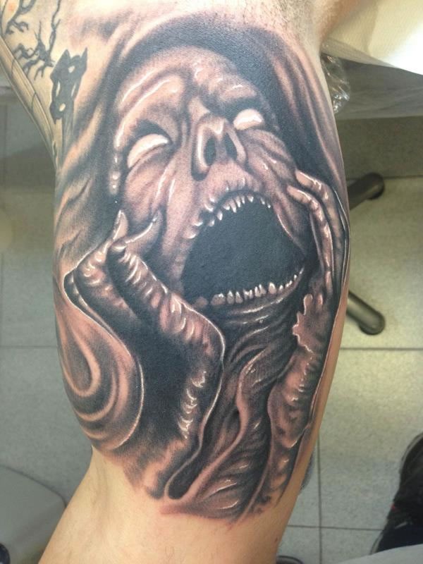 Black ink horror style creepy monster woman face tattoo on biceps