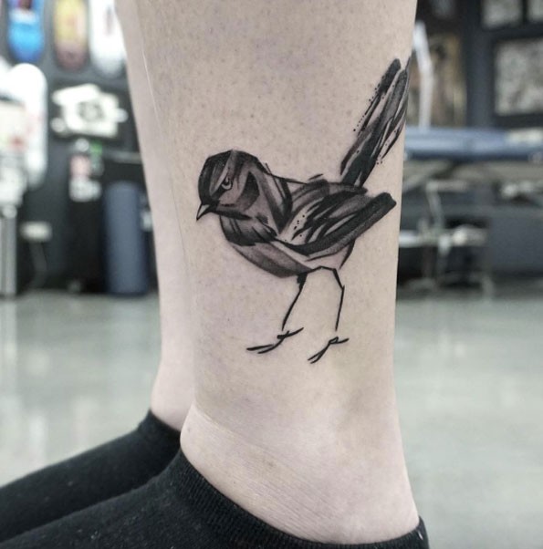 Black ink illustrative style leg tattoo of small bird