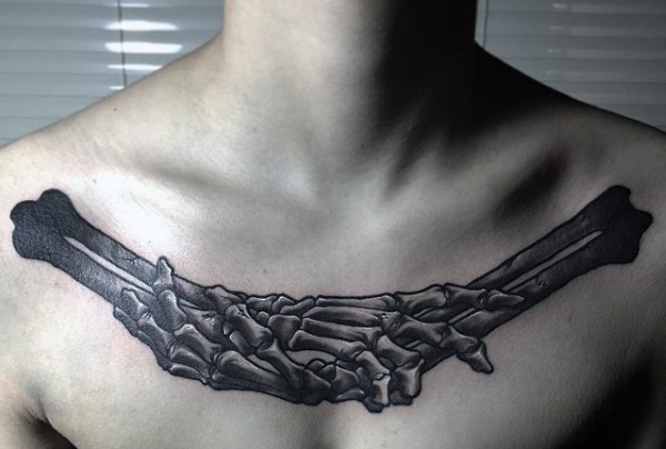 Black ink incredible looking collarbone tattoo of human bone hands