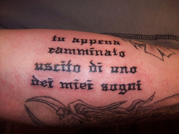 Black ink italian quote tattoo on arm