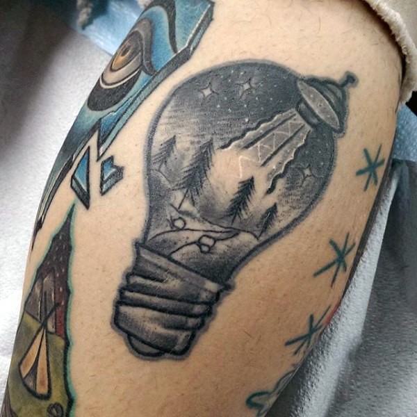 Black ink leg tattoo of bulb stylized with night forest and alien ship