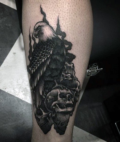 Black ink leg tattoo of detailed crow with skulls and candles
