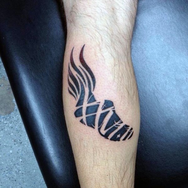 Black ink leg tattoo of sneakers with flames