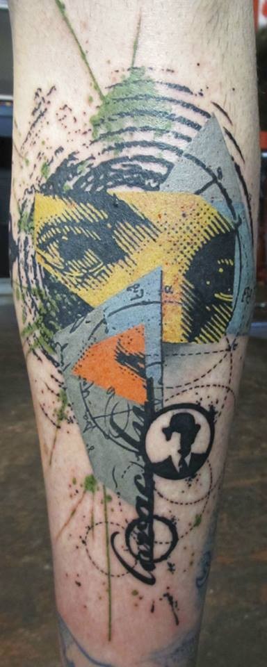 Black ink leg tattoo of various figures and human eye