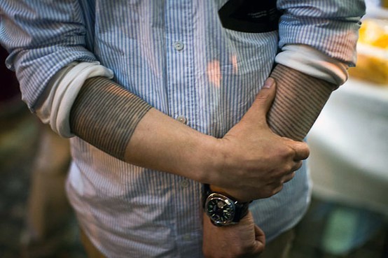 Black ink lines shirt like ornament sleeve tattoo on both arms