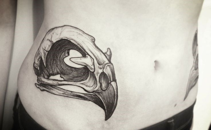 Black ink linework style animal skull tattoo on waist