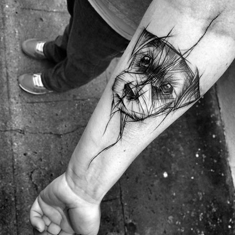 Black ink linework style forearm tattoo of funny puppy by Inez Janiak