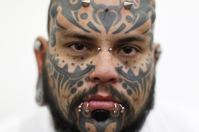 Black ink Maori style detailed face tattoo
