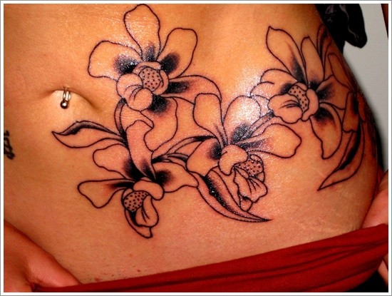 Black ink orchids tattoo on stomach