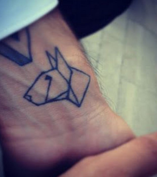 Black ink origami dog tattoo on wrist