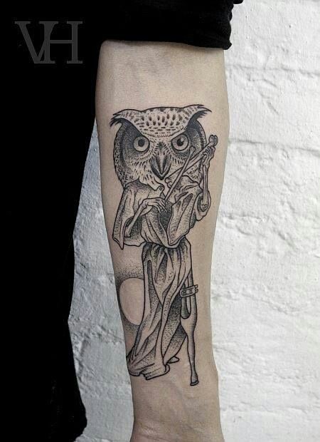 Black ink owl with bones forearm tattoo