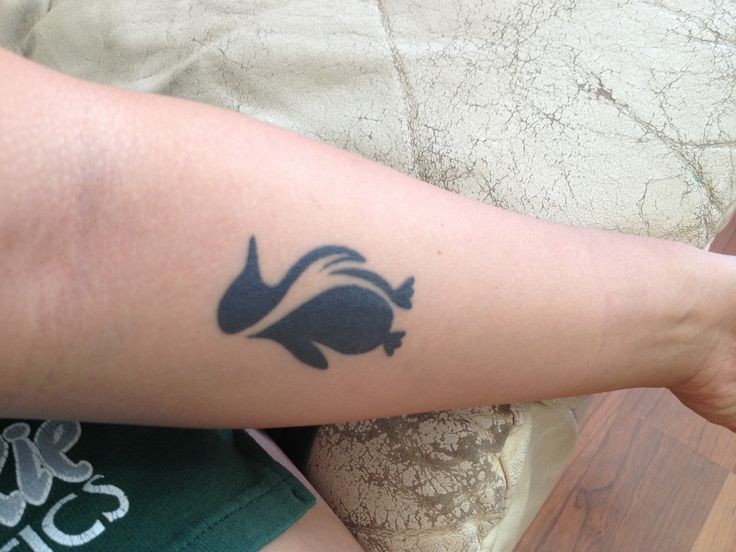 Black ink penguin tattoo on girls wrist