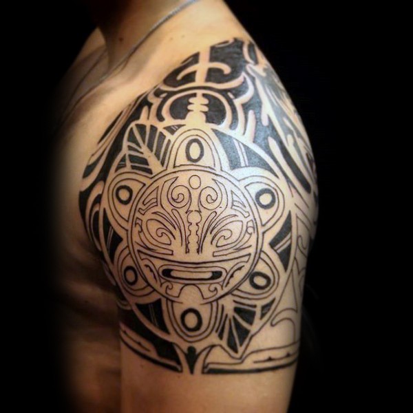 Black ink Polynesian style shoulder tattoo of various ornaments