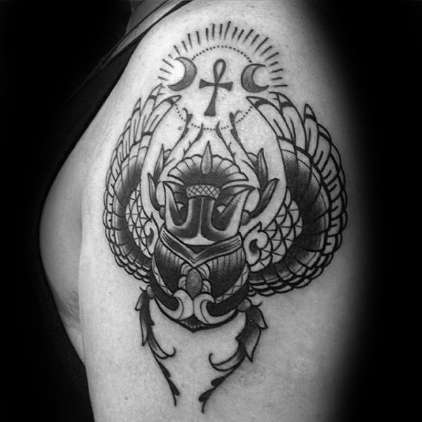 Black ink shoulder tattoo of big bug and symbols
