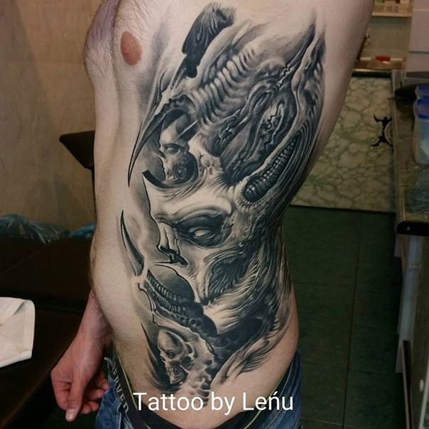 Black ink side tattoo of alien skeleton
