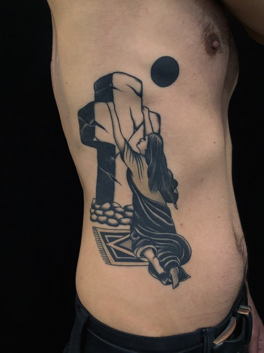 Black ink side tattoo of woman with stone cross and dark moon
