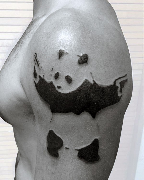 Black ink strange looking shoulder tattoo of panda bear with pistols