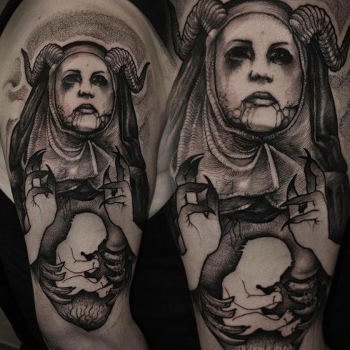 Black ink style creepy looking shoulder tattoo of demonic woman with little baby