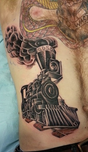 Black ink train tattoo painted in old school style on belly