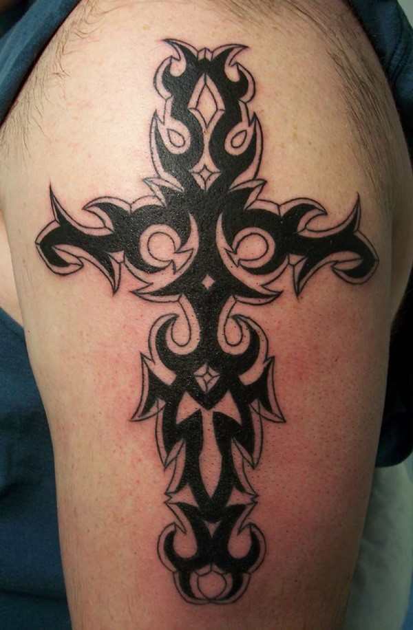 Tatuaje en el brazo,
cruz tribal, tinta negra