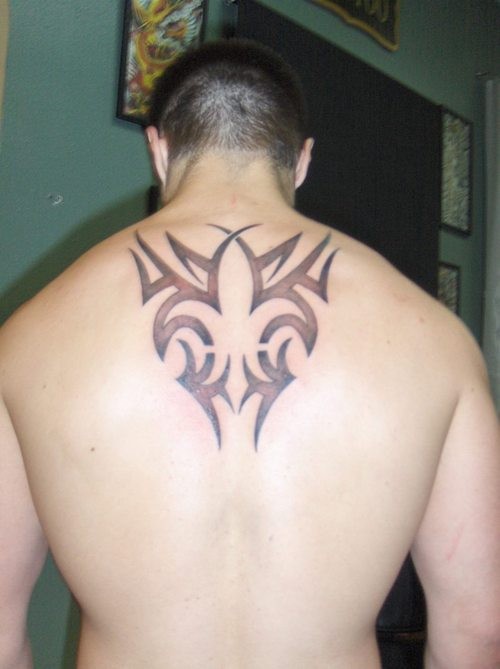 Black ink tribal fleur de lis tattoo on back