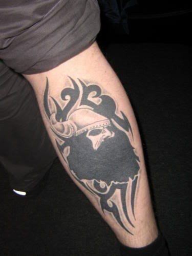 Black ink tribal viking tattoo on leg