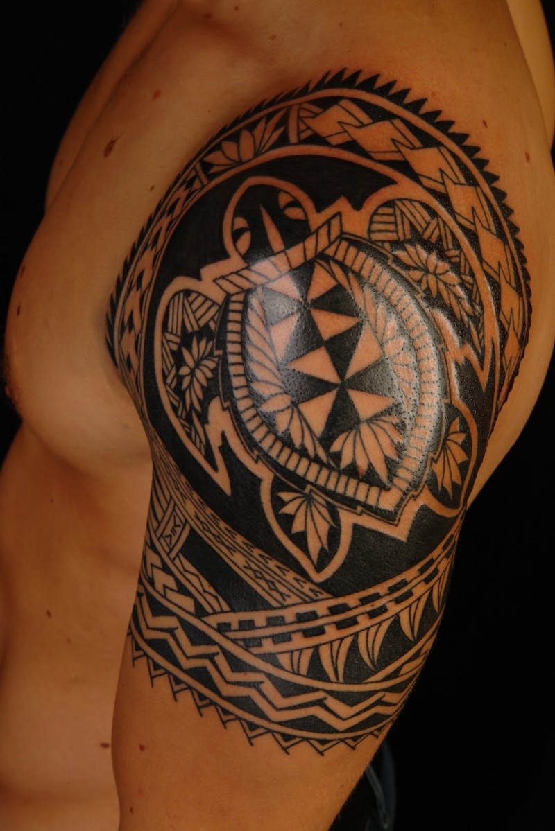 Black ink turtle tattoo on shoulder in polynesian style