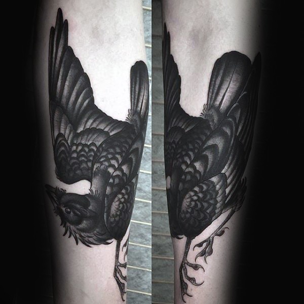 Black ink typical illustrative style arm tattoo of crow