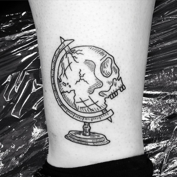 Black ink typical looking leg tattoo of skull shaped globe
