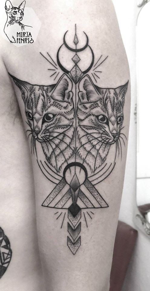 Black ink typical shoulder tattoo of mirrored cats
