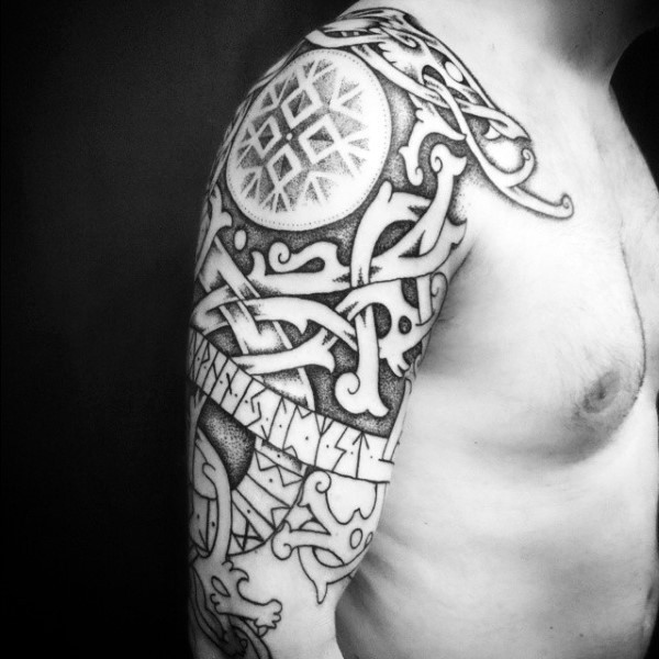 Black ink usual medieval ornaments tattoo on shoulder with lettering