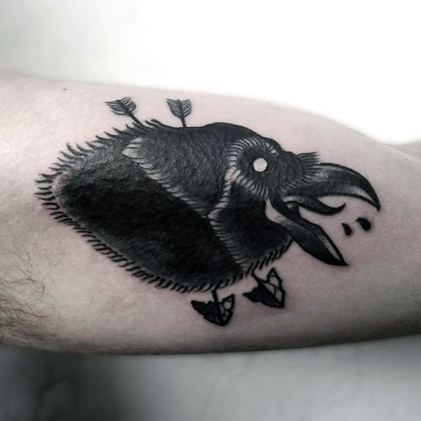 Black ink very detailed arm tattoo of crow head with arrows