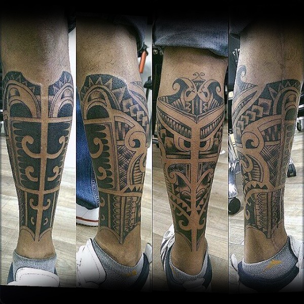 Black ink very detailed leg tattoo of ancient ornaments