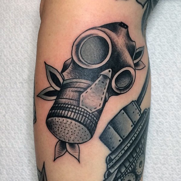 Black ink vintage style gas mask tattoo on arm