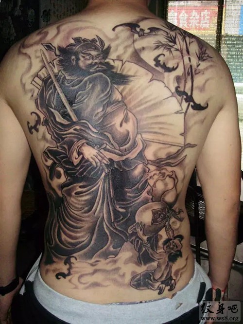 Black ink whole back tattoo of creepy man warrior with flowers