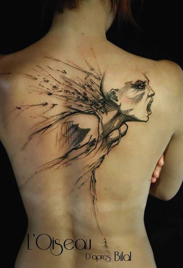 Black ink whole back tattoo of creepy looking screaming woman