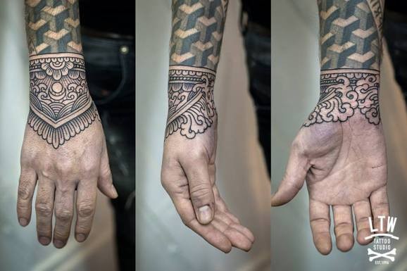 Black linework wrist tattoo by Jorge Teran