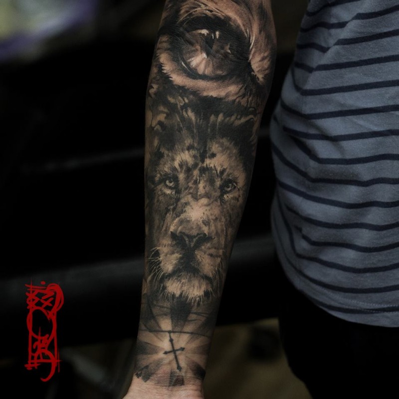 Black lion tattoo on forearm
