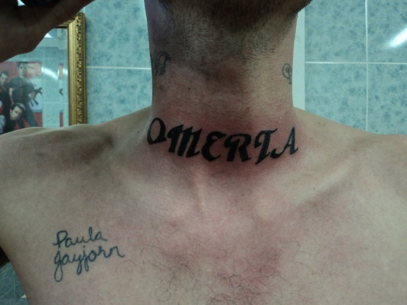 Black omerta lettering throat tattoo
