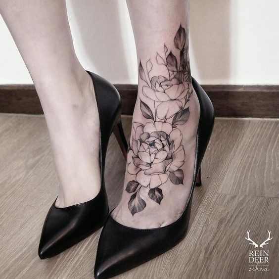Black outline style nice looking ankle tattoo of big roses with leaves