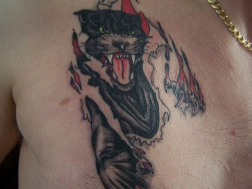 Black panther ripping skin tattoo on chest
