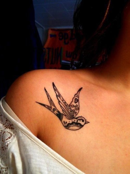 Black patchwork bird tattoo on shoulder
