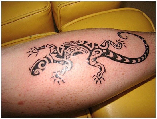 Black patchwork lizard tattoo on leg